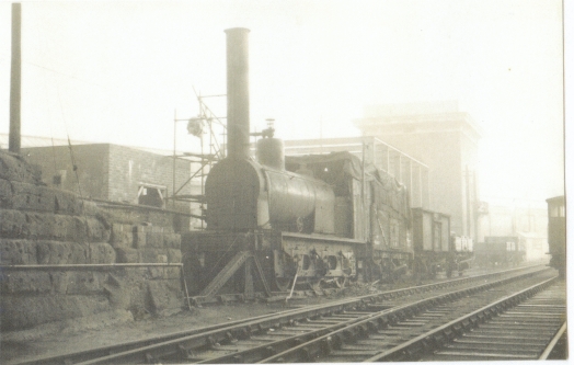 Locomotive and trucks on siding